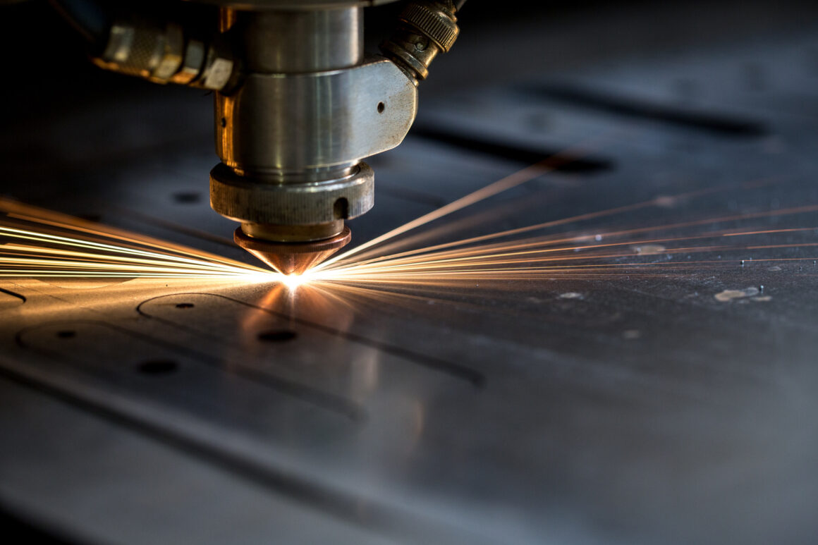 Cutting of metal. Sparks fly from laser