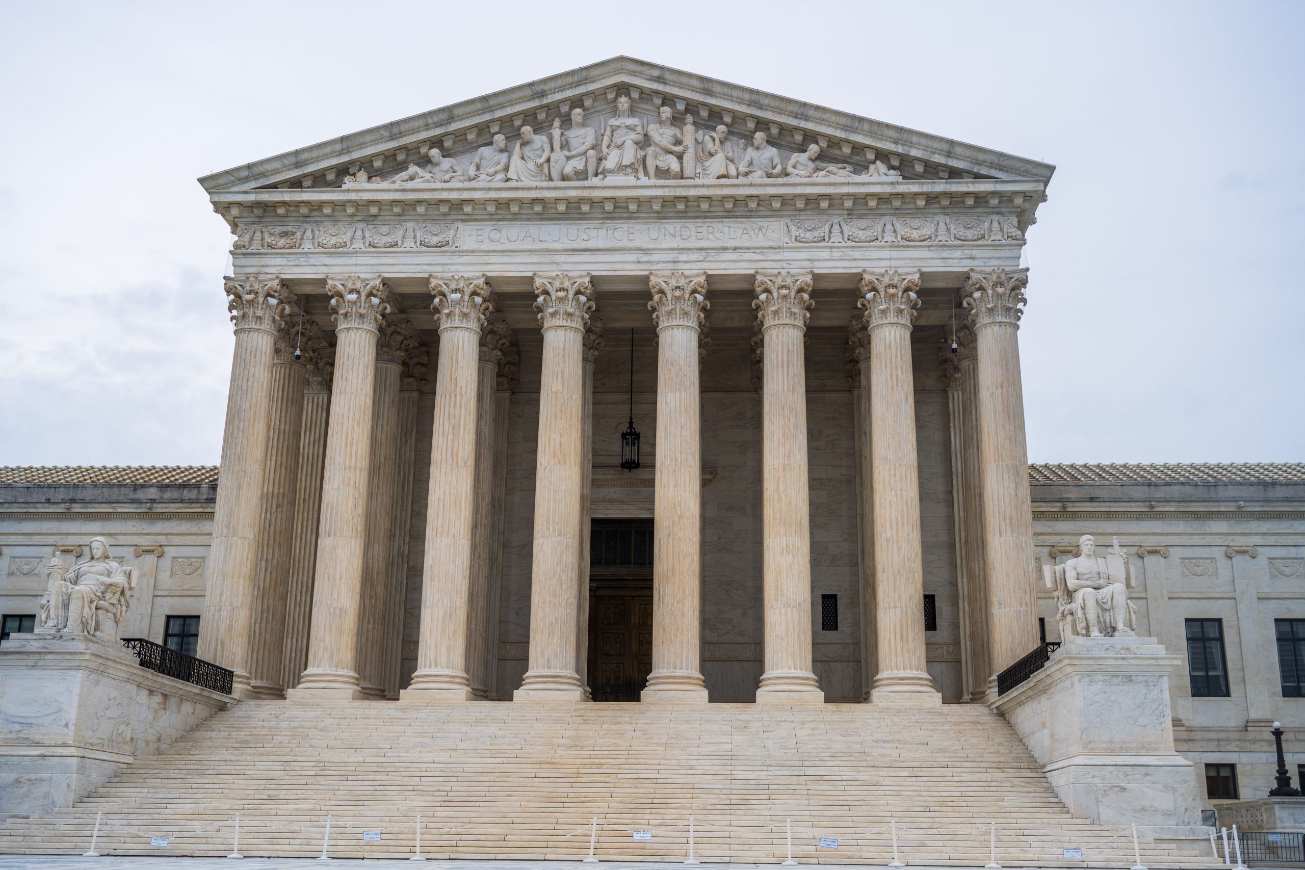 Front view of the US Supreme Court building with grand columns representing the litigation process
