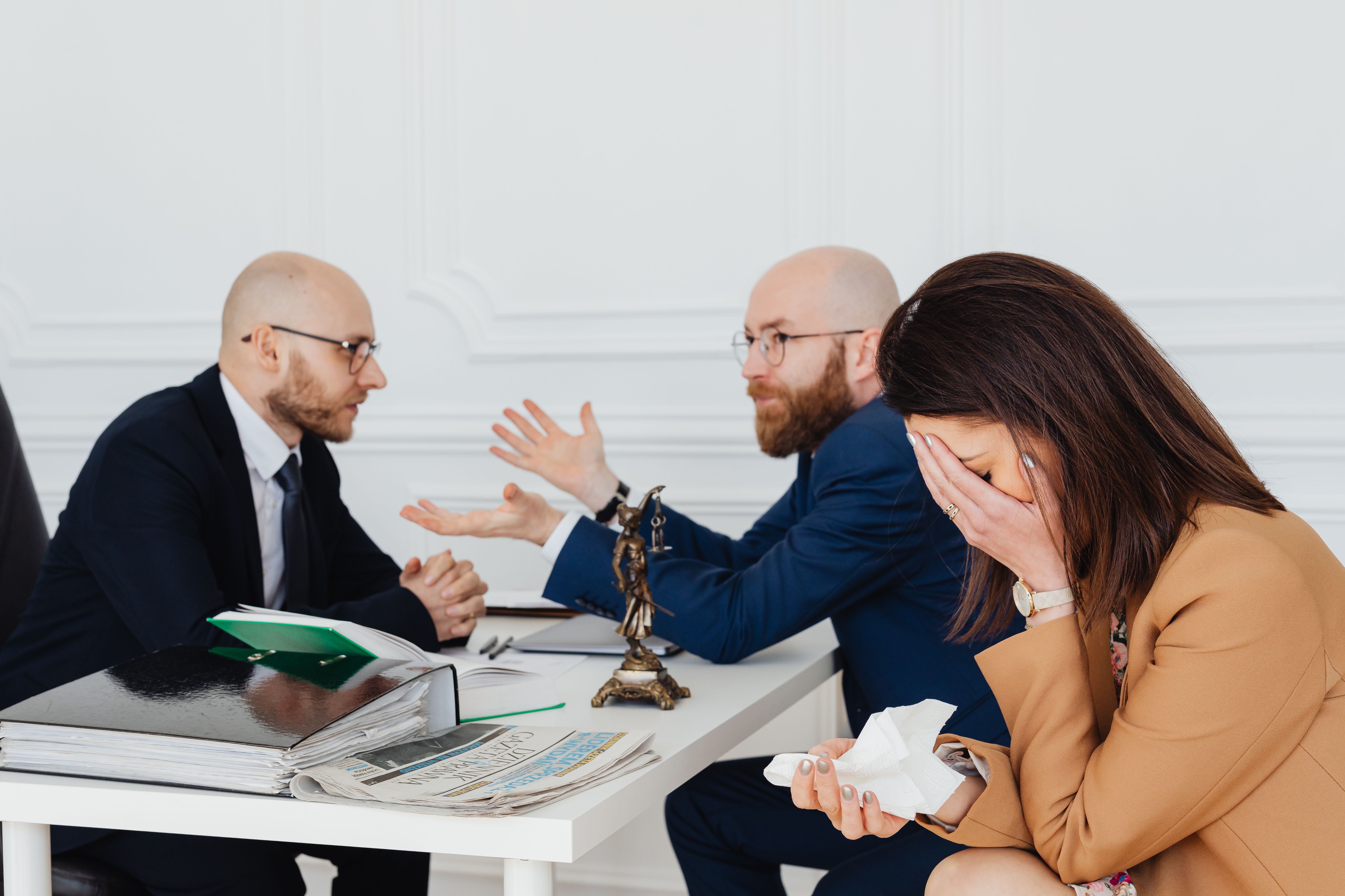 Lawyer mediating a settlement discussion with clients in a legal office